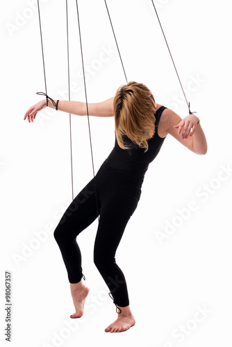 Puppet. Conceptual image of a girls-marionette isolated on white background. photo