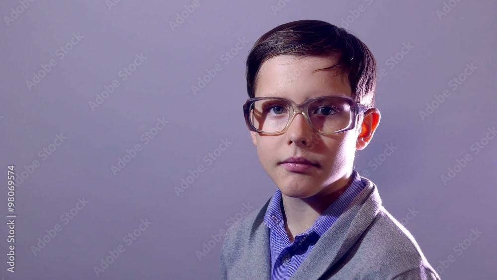 boy teenager nerd portrait schoolboy corrects touches glasses on purple background education boy teenager nerd portrait schoolboy corrects touches glasses on purple background education