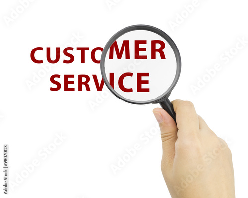 Magnifying glass with word CUSTOMER SERVICE in hand