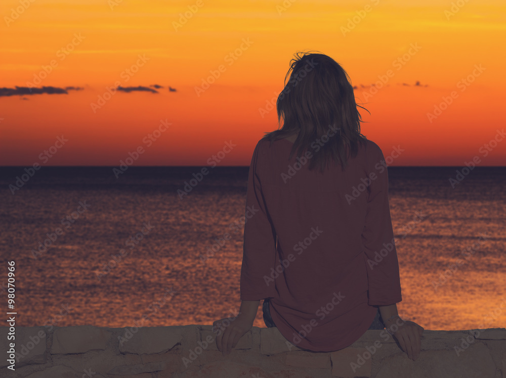 Girl watching the ocean / sea horizon.