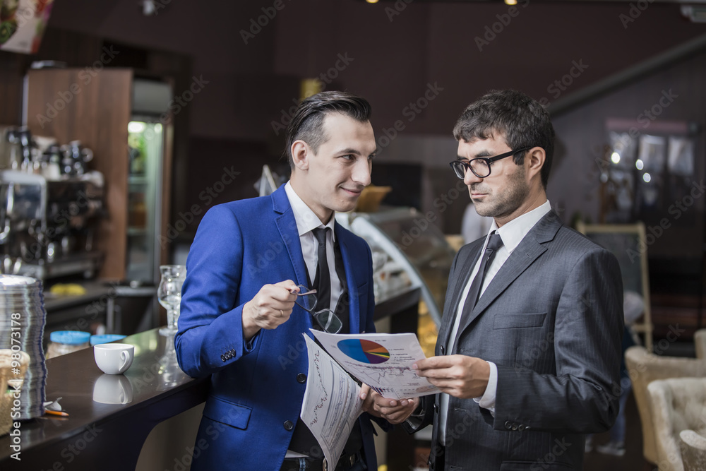 Fototapeta premium two businessmen communicate happily negotiating in the cafe