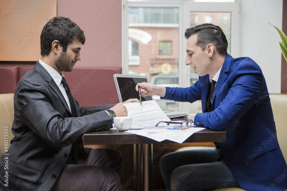 two businessman business partner are negotiating in the cafe two businessman business partner are negotiating in the cafe