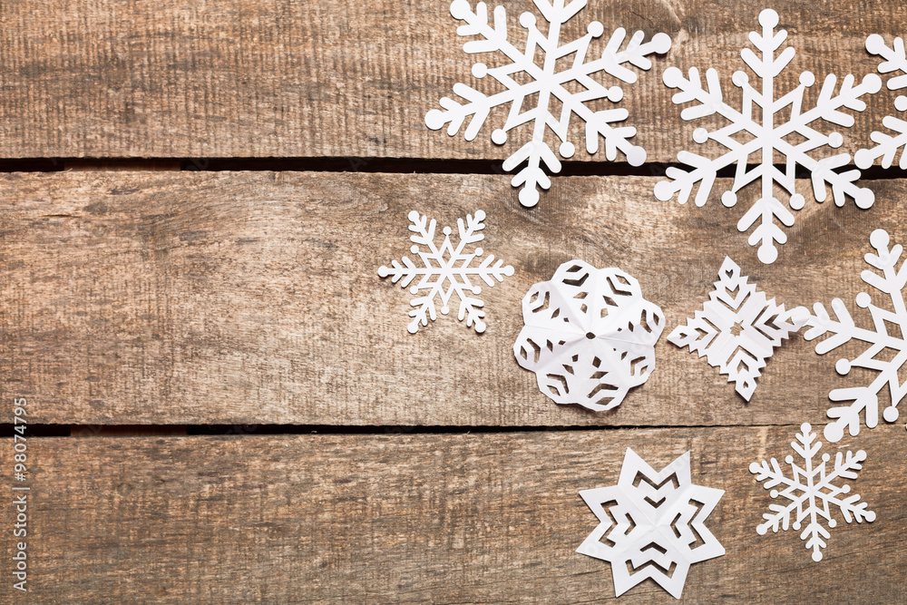 Decorative snowflakes on wooden background Decorative snowflakes on wooden background