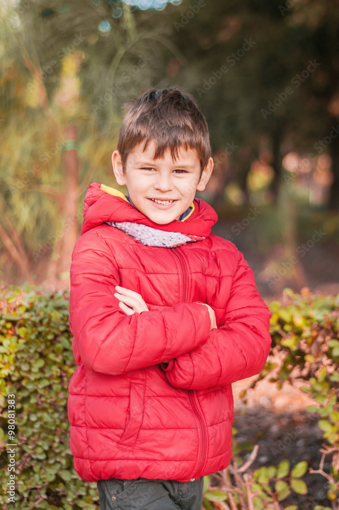 Cheerful, happy boy in the park. It is, hands cross over Cheerful, happy boy in the park. It is, hands cross over