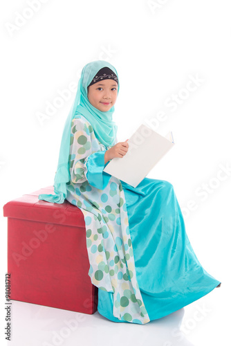 Asian muslim student reading a book