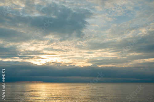 Summer sunset on the beach with clouds over the sky