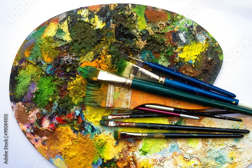Paint brushes to the painting palette with colors 