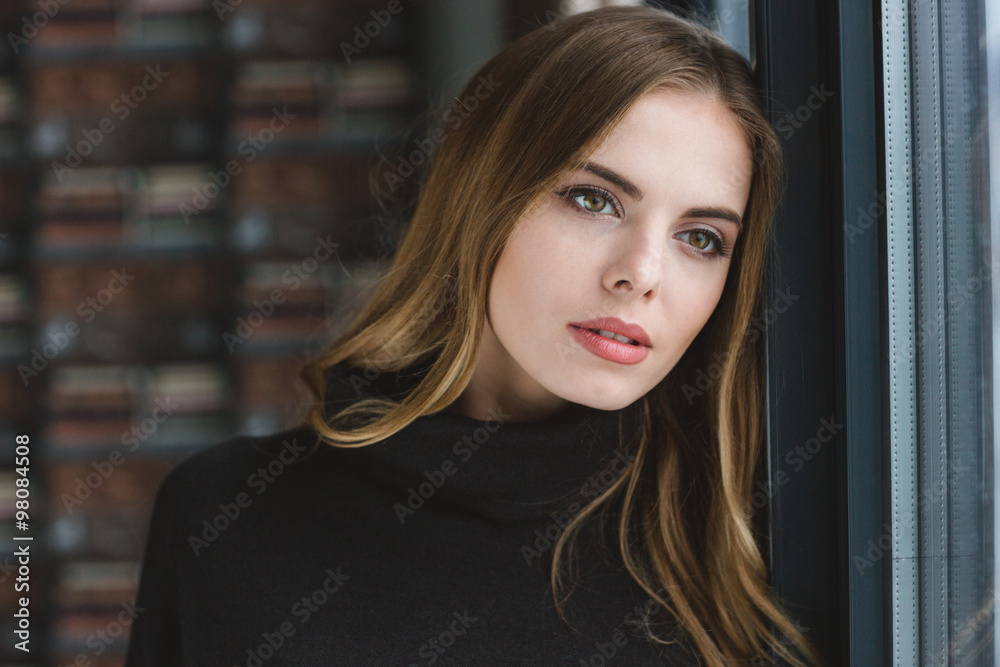 Obraz premium Sensual thoughtful young female dreaming near the window