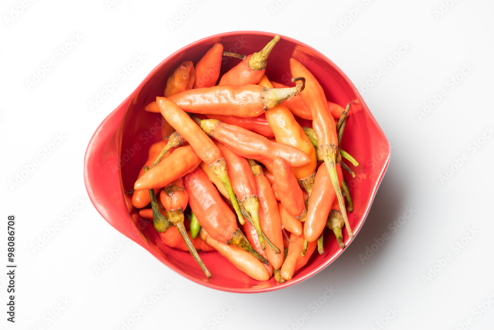 Red Chili in Red measuring cup on White background from Top view Red Chili in Red measuring cup on White background from Top view