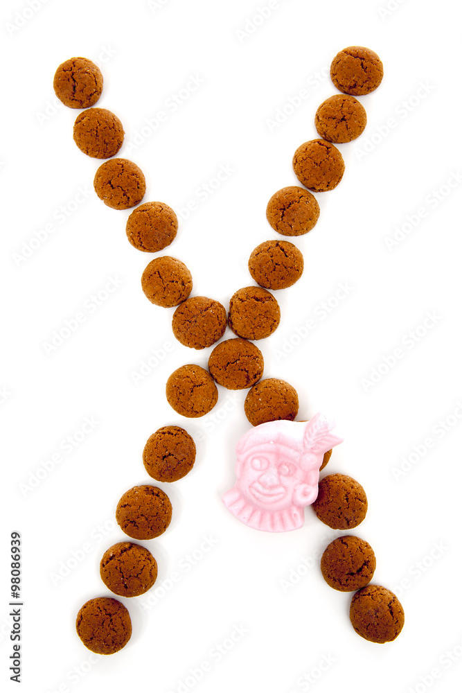 Ginger nuts, pepernoten, in the shape of letter X isolated on wh Ginger nuts, pepernoten, in the shape of letter X isolated on wh