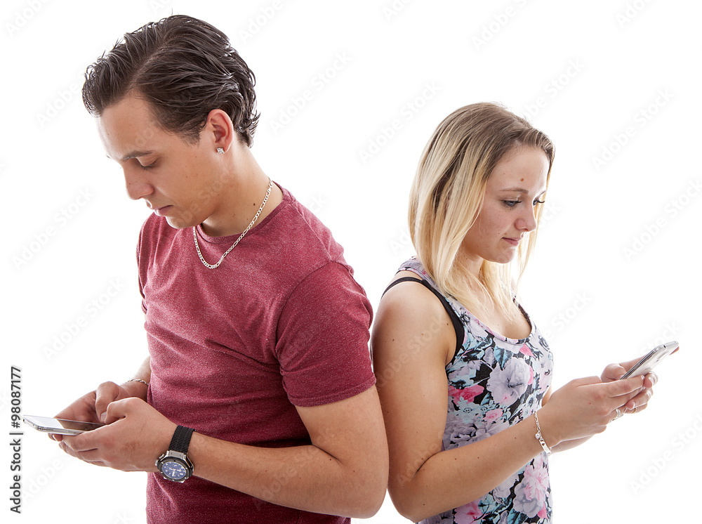 Young couple in disinterest moment with mobile smart phones Young couple in disinterest moment with mobile smart phones