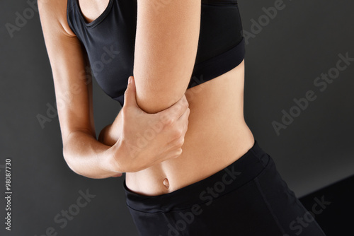 Athletic girl with painful elbow, isolated