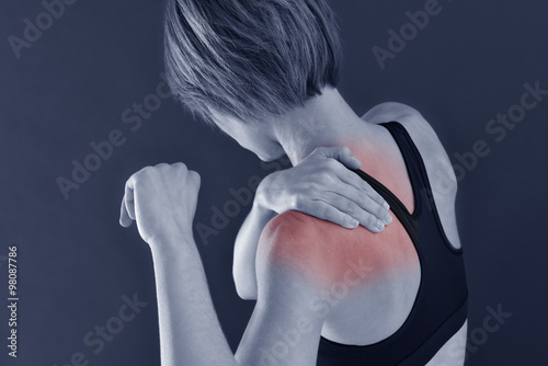 Closeup of fitness girl with shoulder pain, isolated photo