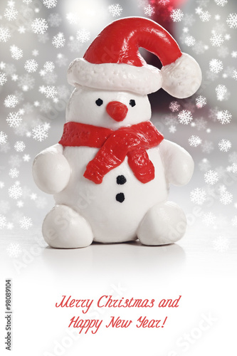 Snowman with Santa Hat. Christmas greeting card with snowflakes © argentum