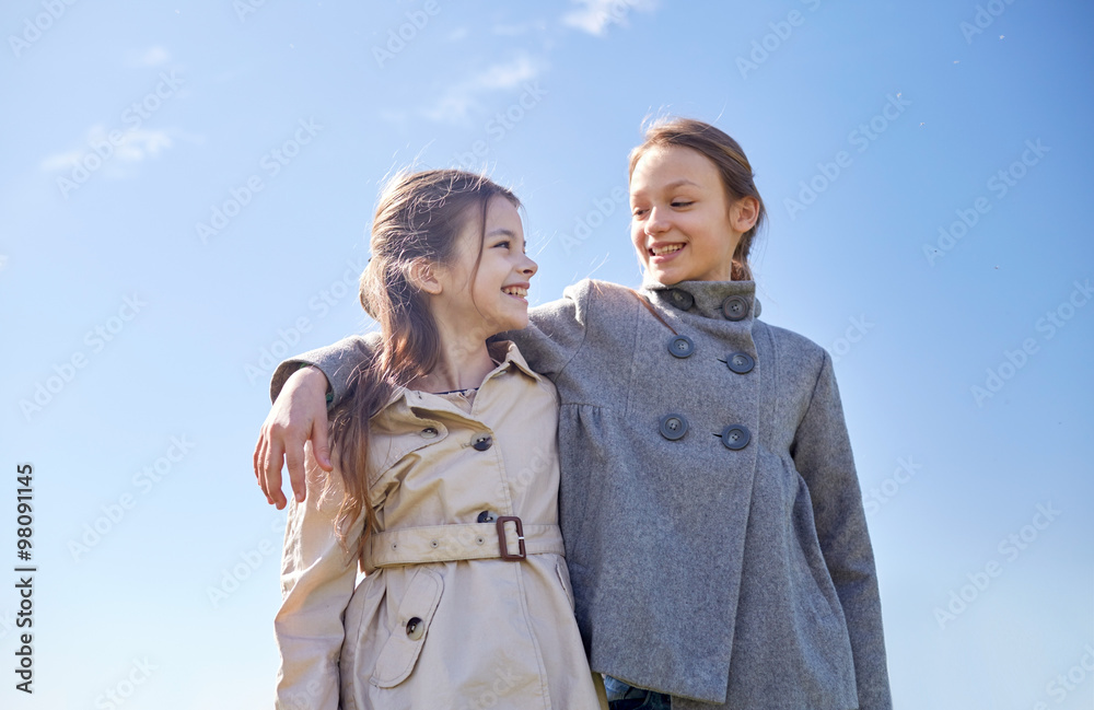 happy little girls hugging and talking outdoors happy little girls hugging and talking outdoors