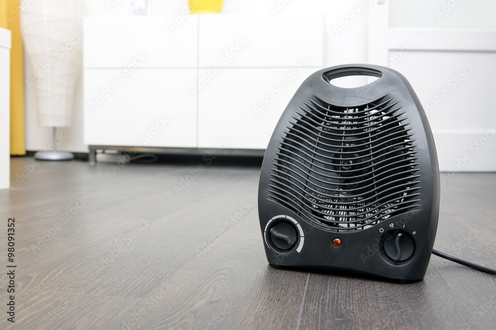 black electric heater on laminate floor in the room black electric heater on laminate floor in the room