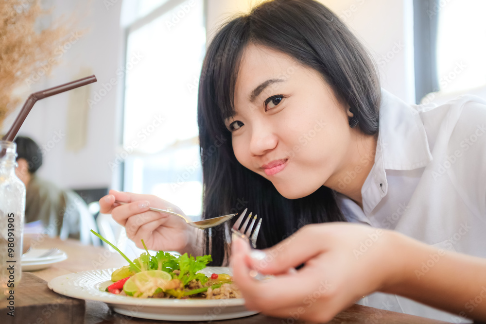 Young business woman on lunch break in restaurant