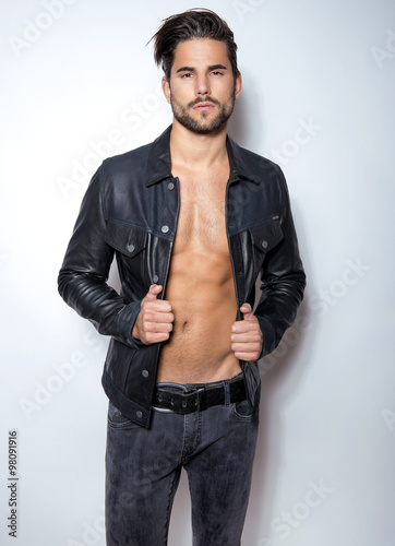 handsome young and fit man posing with open jacket