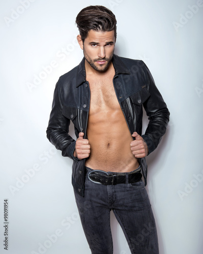 handsome young and fit man posing with open jacket