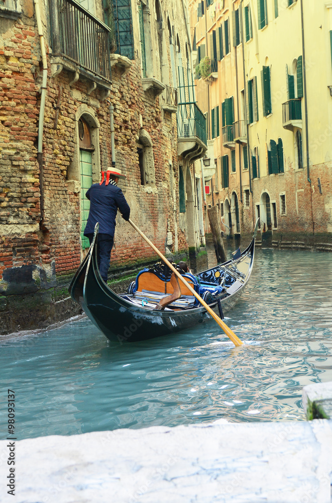 Gondolier on canal, in Venice