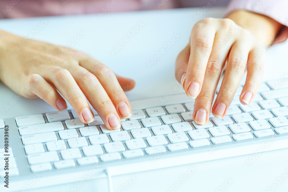 Woman office worker typing on the keyboard Woman office worker typing on the keyboard