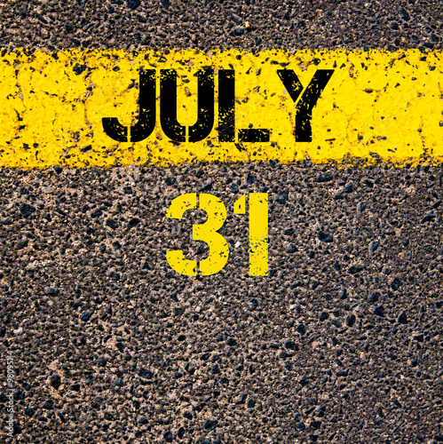 31 July calendar day over road marking yellow paint line photo