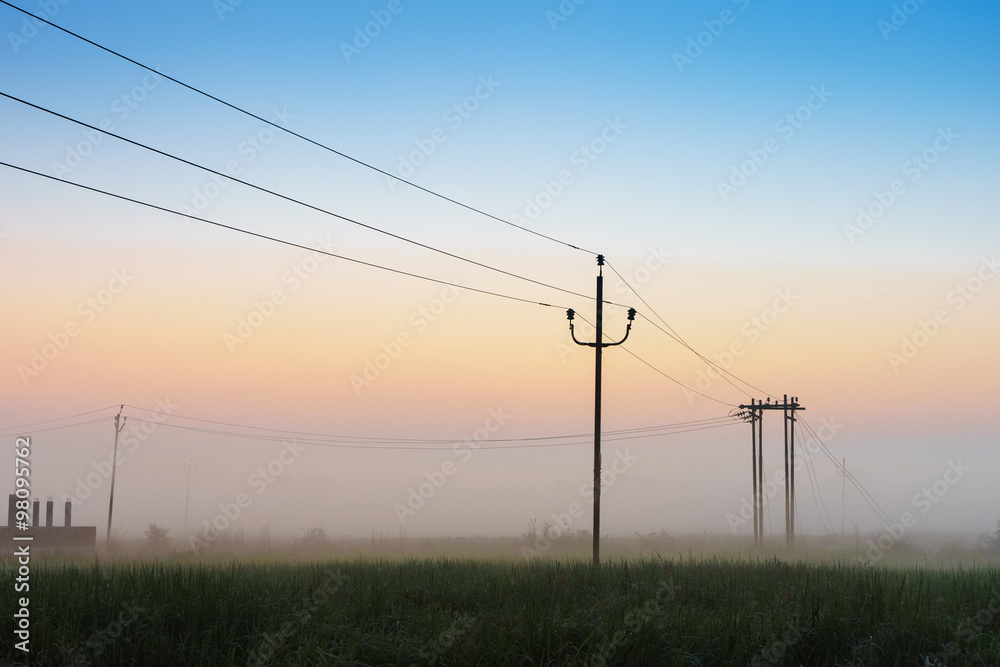 Silhouette pillar and electricity line in countryside