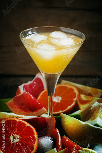 Citrus cocktail with ice and slices of fruit, selective focus
