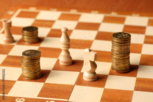 money as the coins are gold coins on the chessboard finance conc