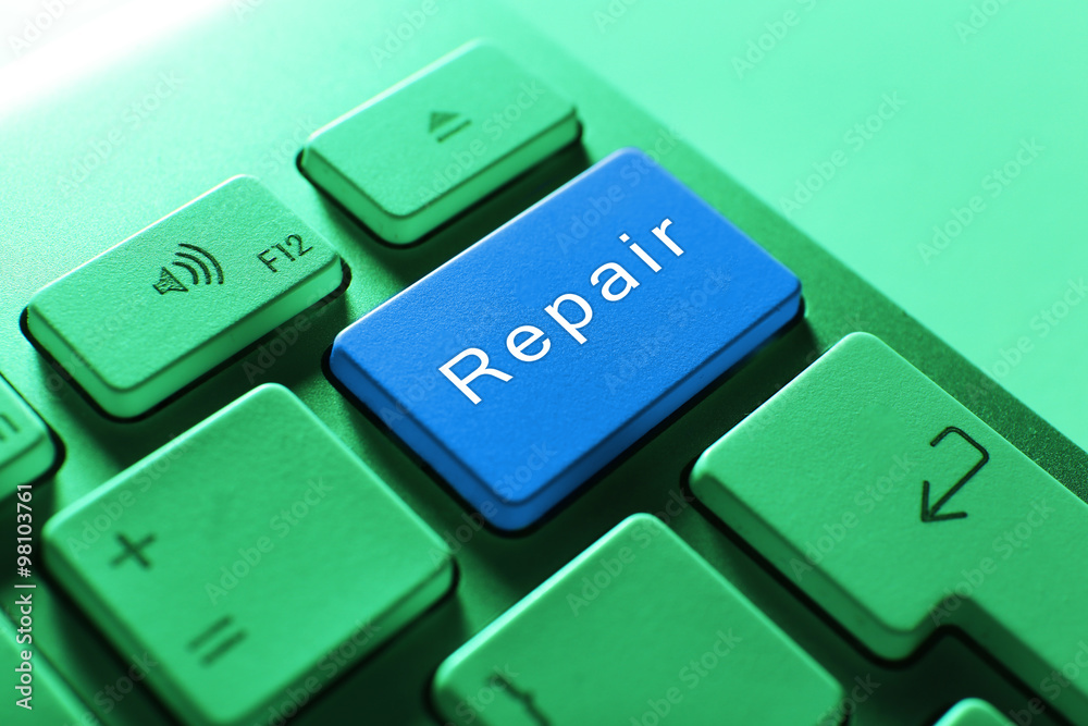 Close-up of laptop keyboard with color button and word Repair Close-up of laptop keyboard with color button and word Repair