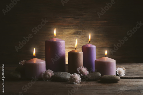 Spa set with candles  pebbles and flowers on wooden background
