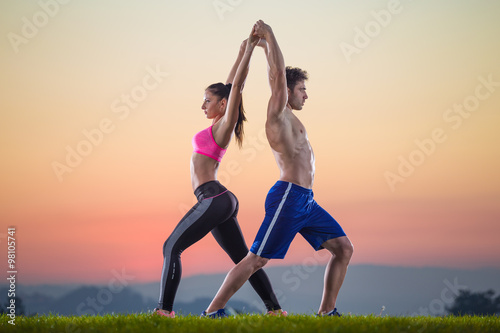 fitness pair on sunset
