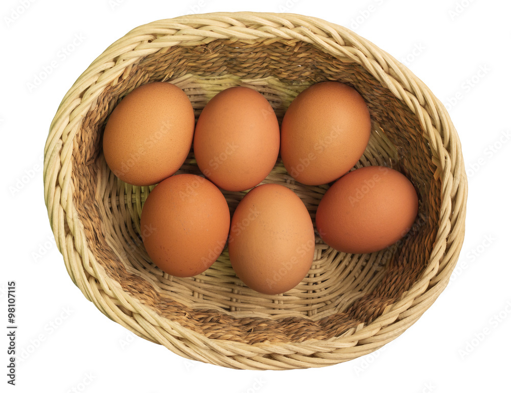 Eggs in a wicker basket on a white background, top view Eggs in a wicker basket on a white background, top view