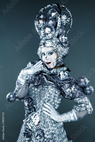 Portrait of young woman with creative silver make-up for carnival