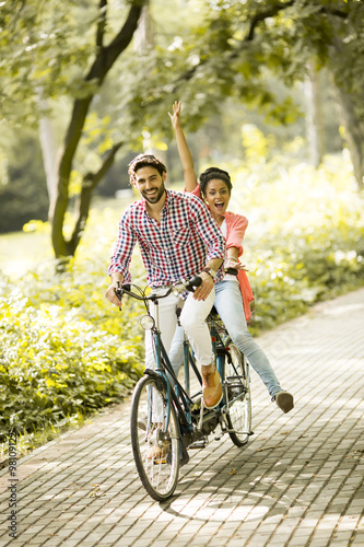 Young couple riding on the bicycle