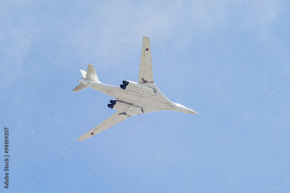 Tupolev Tu-160M (Blackjack) supersonic, variable-sweep wing heavy strategic bomber flies on blue sky background Tupolev Tu-160M (Blackjack) supersonic, variable-sweep wing heavy strategic bomber flies on blue sky background