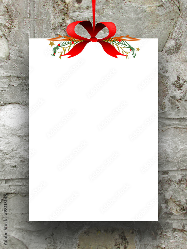 Single empty rectangular paper sheet frame with Xmas ribbon decoration on ancient stone wall background 
