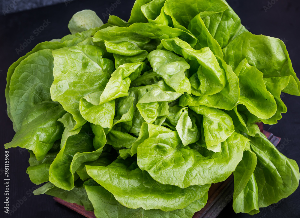 Fresh green lettuce salad on black table Fresh green lettuce salad on black table