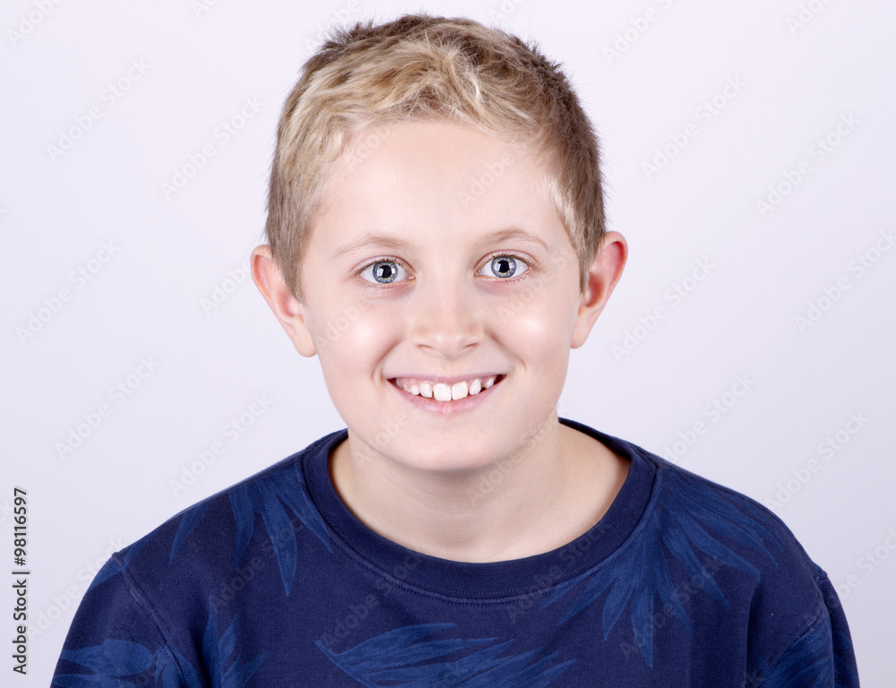 portrait of a happy teenage boy on a white background in a blue sweater portrait of a happy teenage boy on a white background in a blue sweater