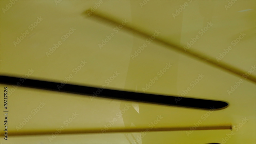 Closer look of the turning fan inside the building with the black strips on it Closer look of the turning fan inside the building with the black strips on it