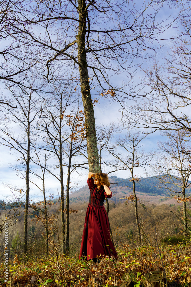 Woman in red dress portrait, autumnal forest Woman in red dress portrait, autumnal forest