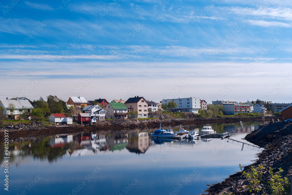 Village on the norwegian island with reflection in water