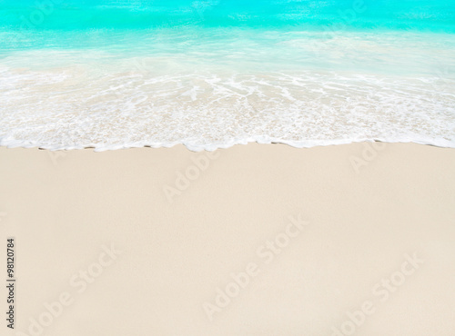 Ocean wave and white sand at tropical beach, vacation background