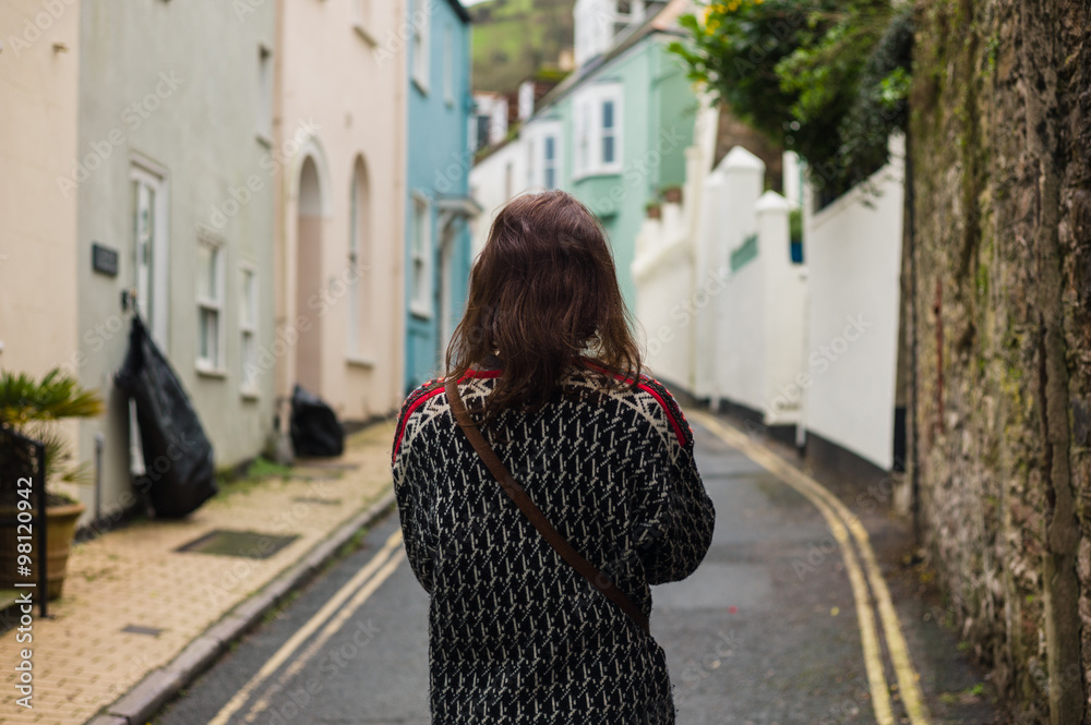 Young woman walking in small village Young woman walking in small village