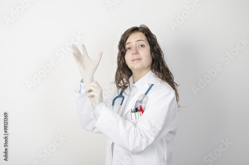 Female doctor putting latex gloves.