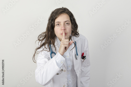 Young woman doctor asking for silence.