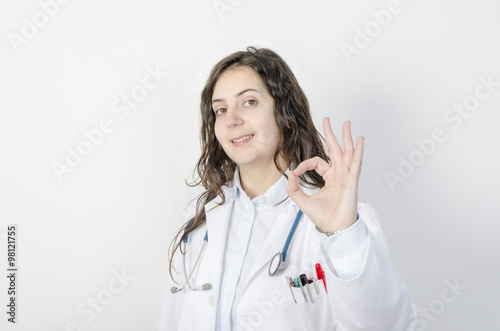 Young woman doctor making the OK gesture.