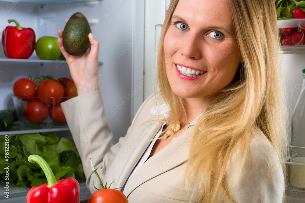 Attractive business woman showing vegetables for healthy eating Attractive business woman showing vegetables for healthy eating