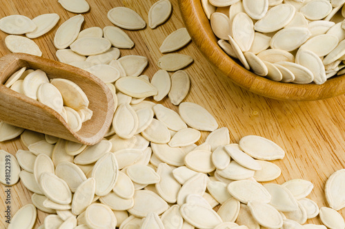 dried pumpkin seeds, on wooden background.