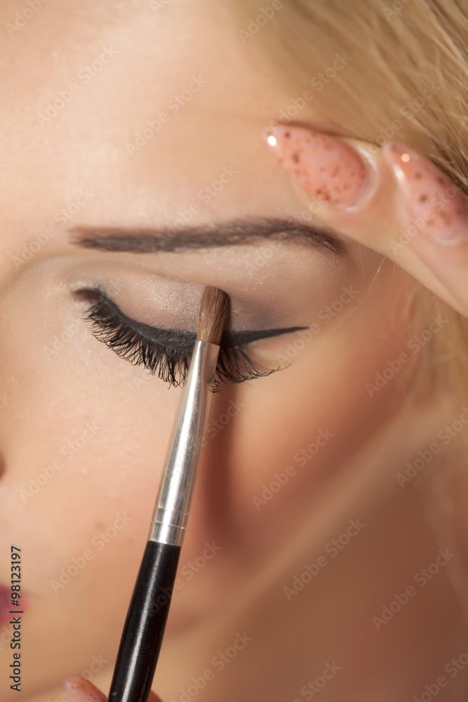 closeup of applying eye shadow with a brush